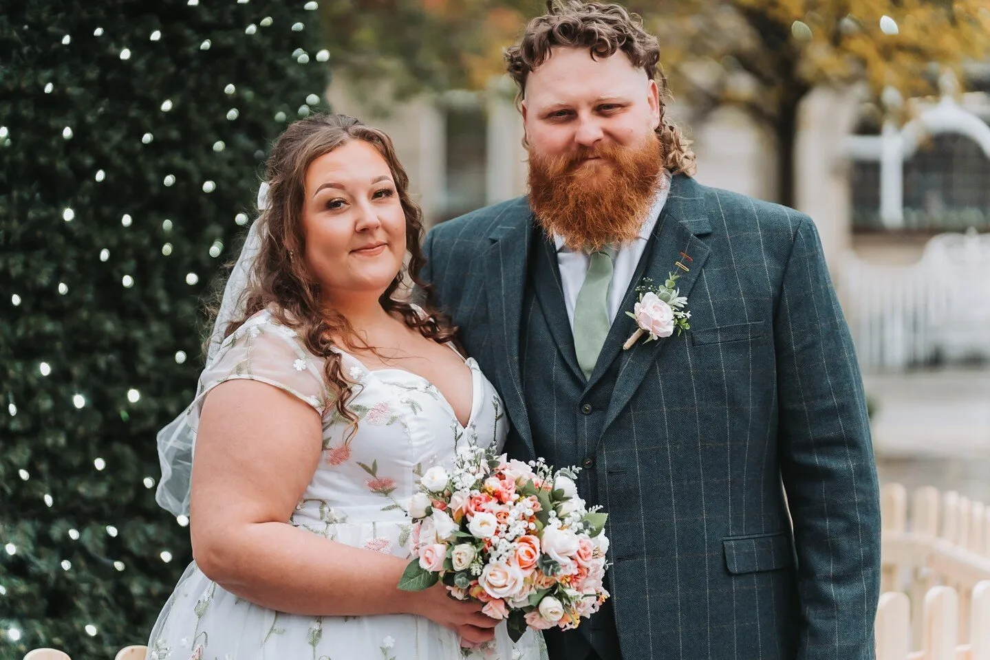 Wedding couple portrait with bouquet and fairy lights